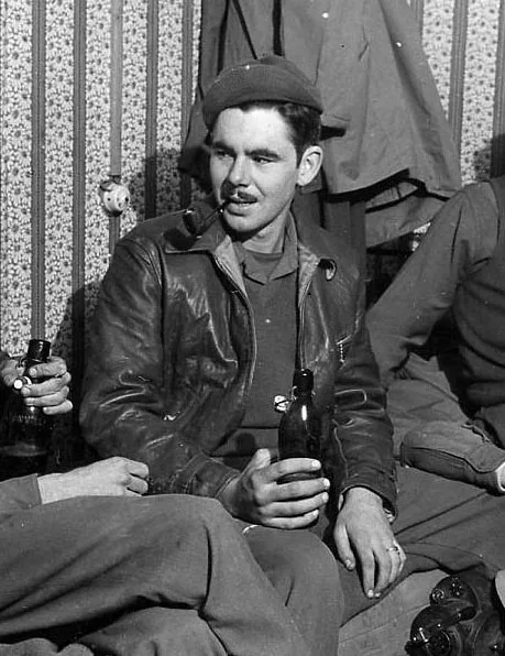 Black and white portrait photograph of a young military serviceman in U.S. Army uniform with garrison cap, looking directly at the camera with a slight smile, circa 1944-1945.